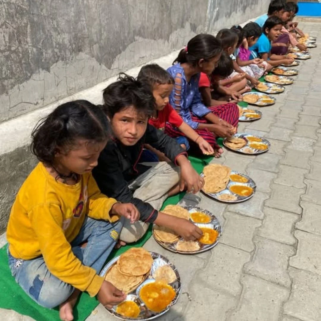 Volunteers serving hot meals during a community food distribution